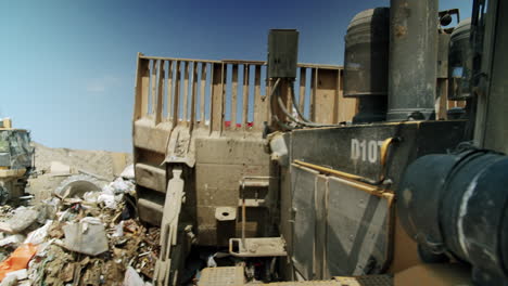 heavy machinery working in a large landfill