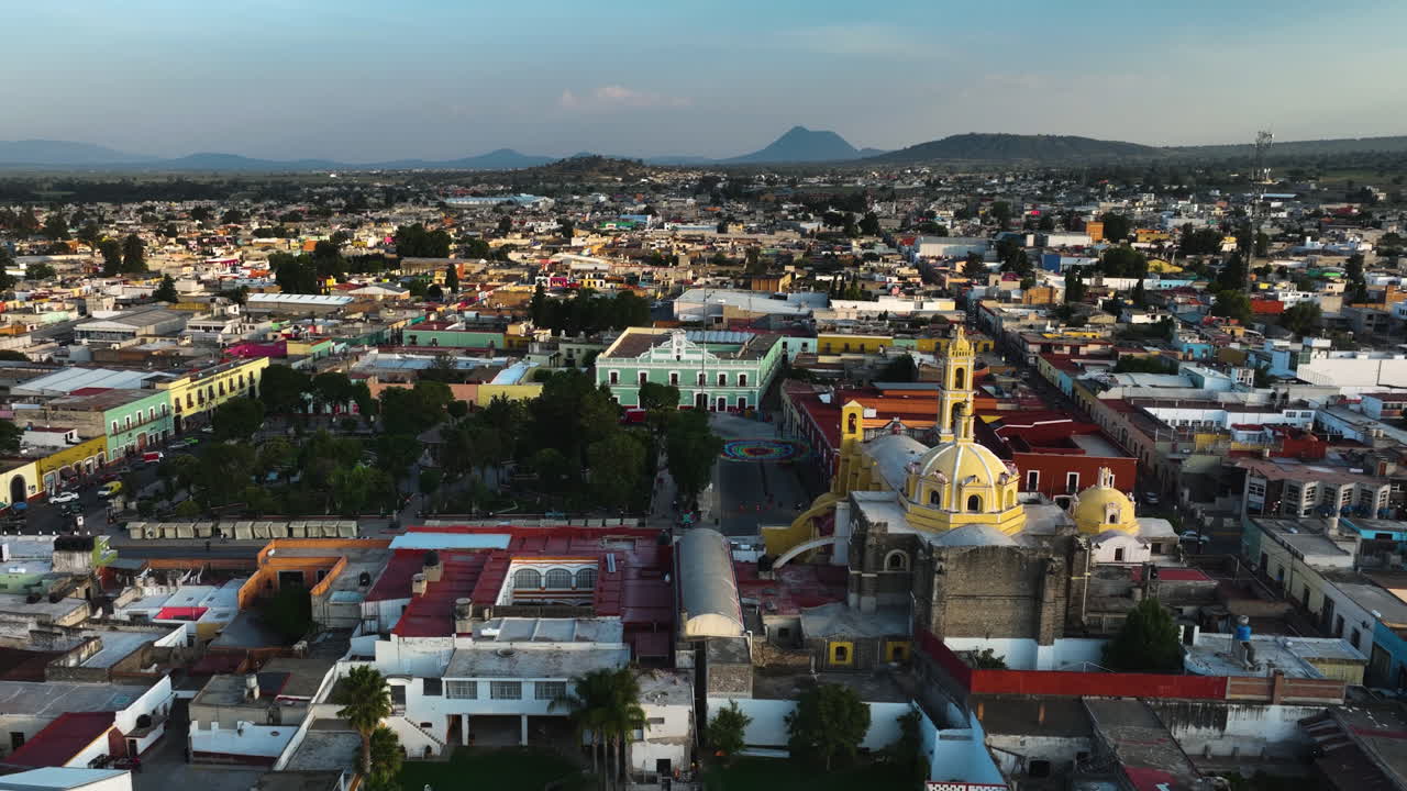 Drone rising over the cityscape of Huamantla, golden hour in Tlaxcala, Mexico