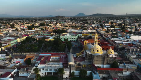 drone rising over the cityscape of huamantla, golden hour in tlaxcala, mexico