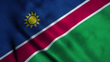 Namibia flag waving in the wind. National flag of Namibia. Sign of Namibia seamless loop animation. 4K