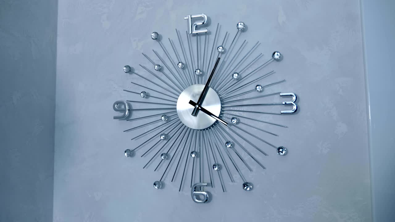 Beautiful chrome wall clocks with decorative glass inserts on the wall
