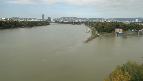 wide panoramic aerial shot of bratislava city, flying over danube river