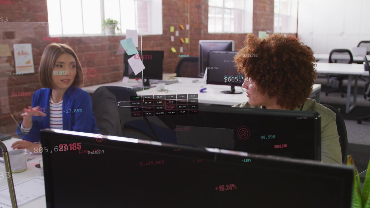 Woman speaking and gesturing man turning, typing reviewing business plan with faint data on screens