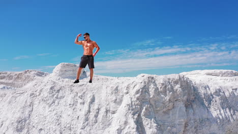Professional bodybuilder posing. Concept of sport outdoors. Aerial view.