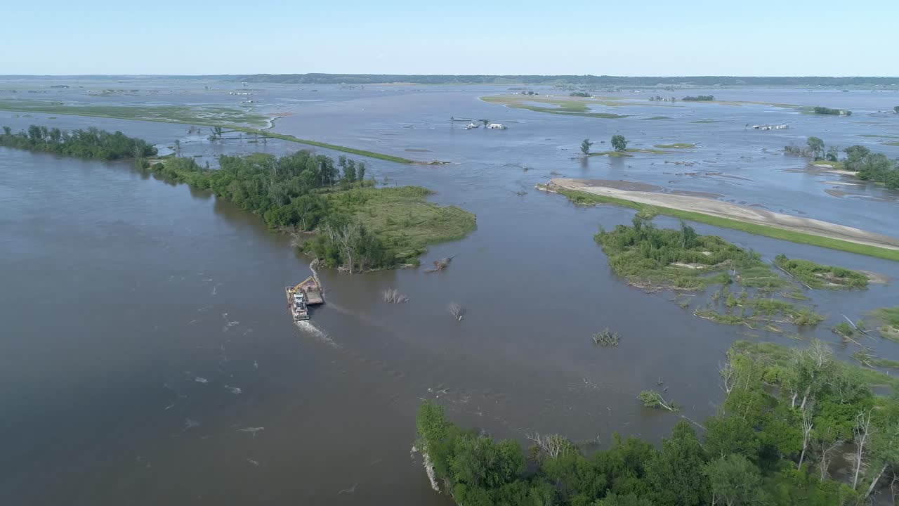 fly over of dredge repair site with rock barges