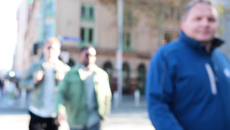 pedestrians crossing a busy street in melbourne