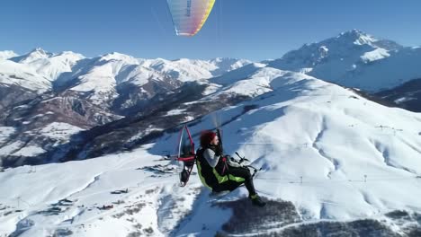 paragliding over snowy mountains