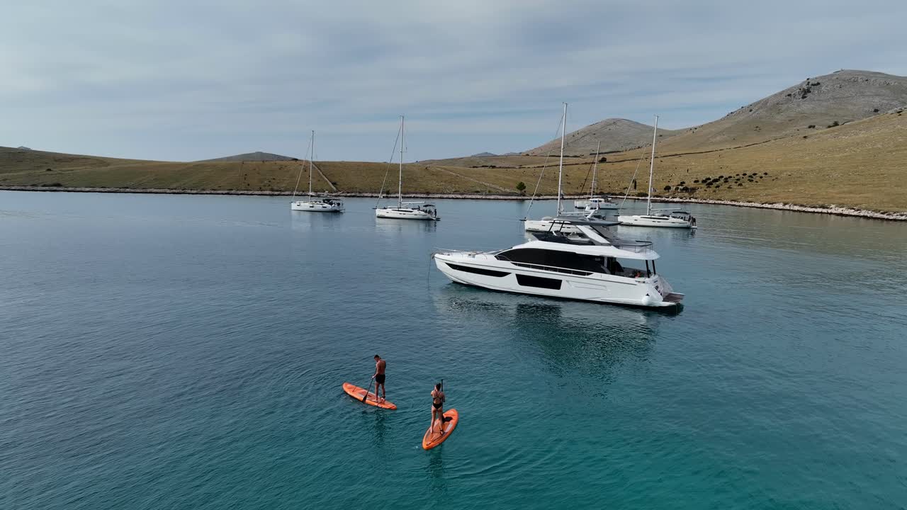 Couple enjoying a summer day stand up pedaling in the region of Kornati, Croatia.