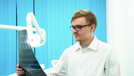 dentist examining x-ray