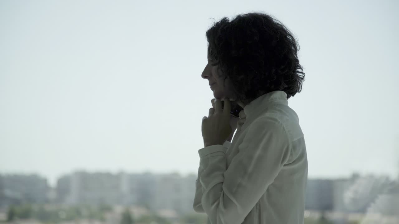 Happy middle aged businesswoman talking by smartphone