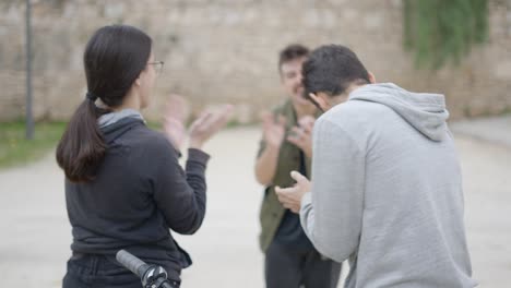 friends playing a card game outdoors