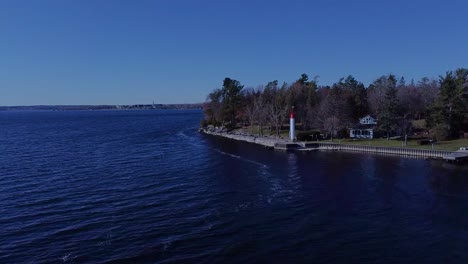 Aerial-of-a-waterfront-with-a-tiny-lighthouse