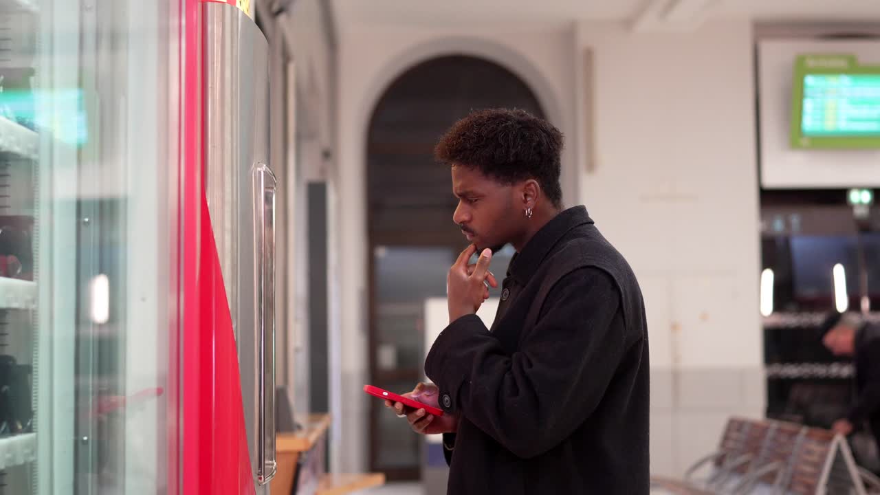 Man using a phone at a vending machine