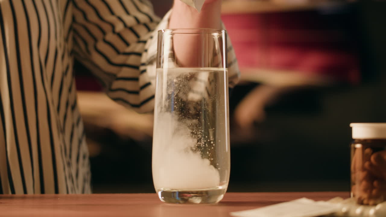 mujer disolviendo medicamentos en agua
