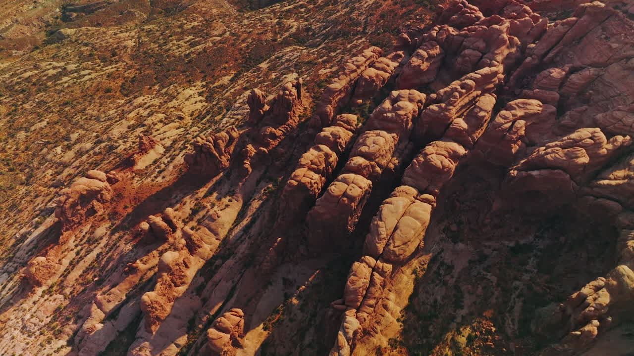 Land of rocks with no greenery and rounded mountains. Aerial view of sunny desert in Utah, USA.