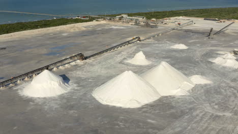 mounds of dried salt in evaporated salt pond in sea saltern in mexico