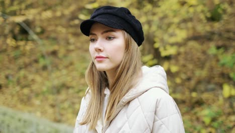 a young beautiful woman walks through the autumn forest