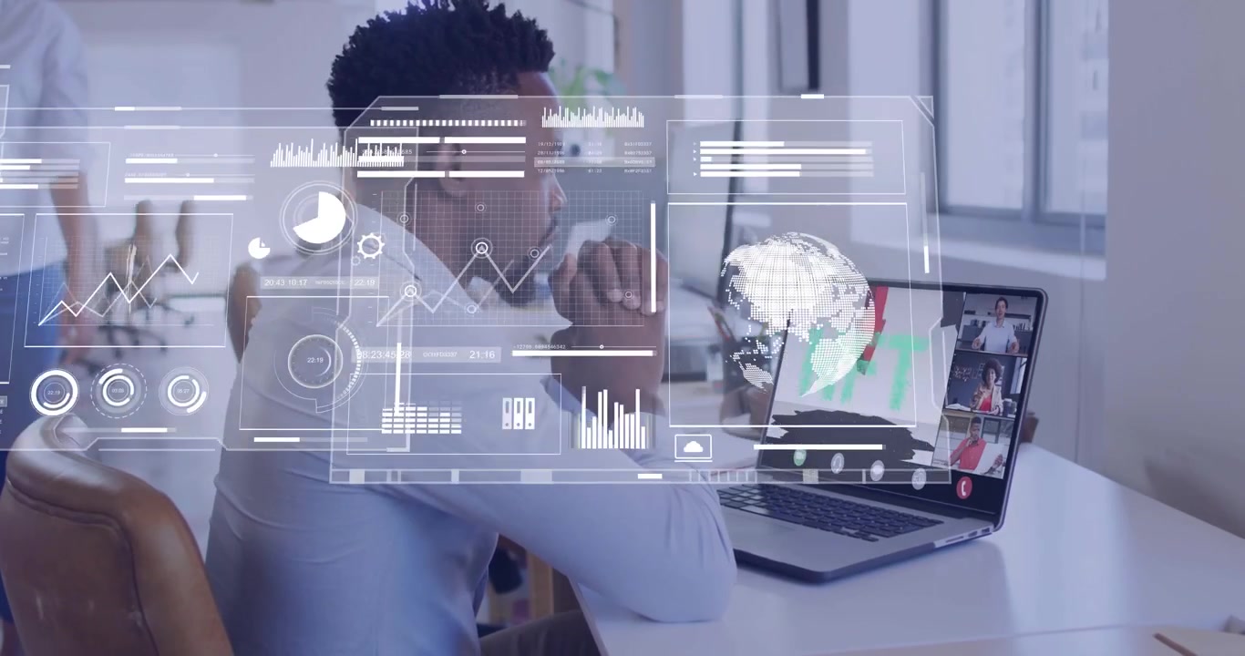 Man at desk joining remote call, viewing NFT deck spawning HUD overlays over laptop showing data