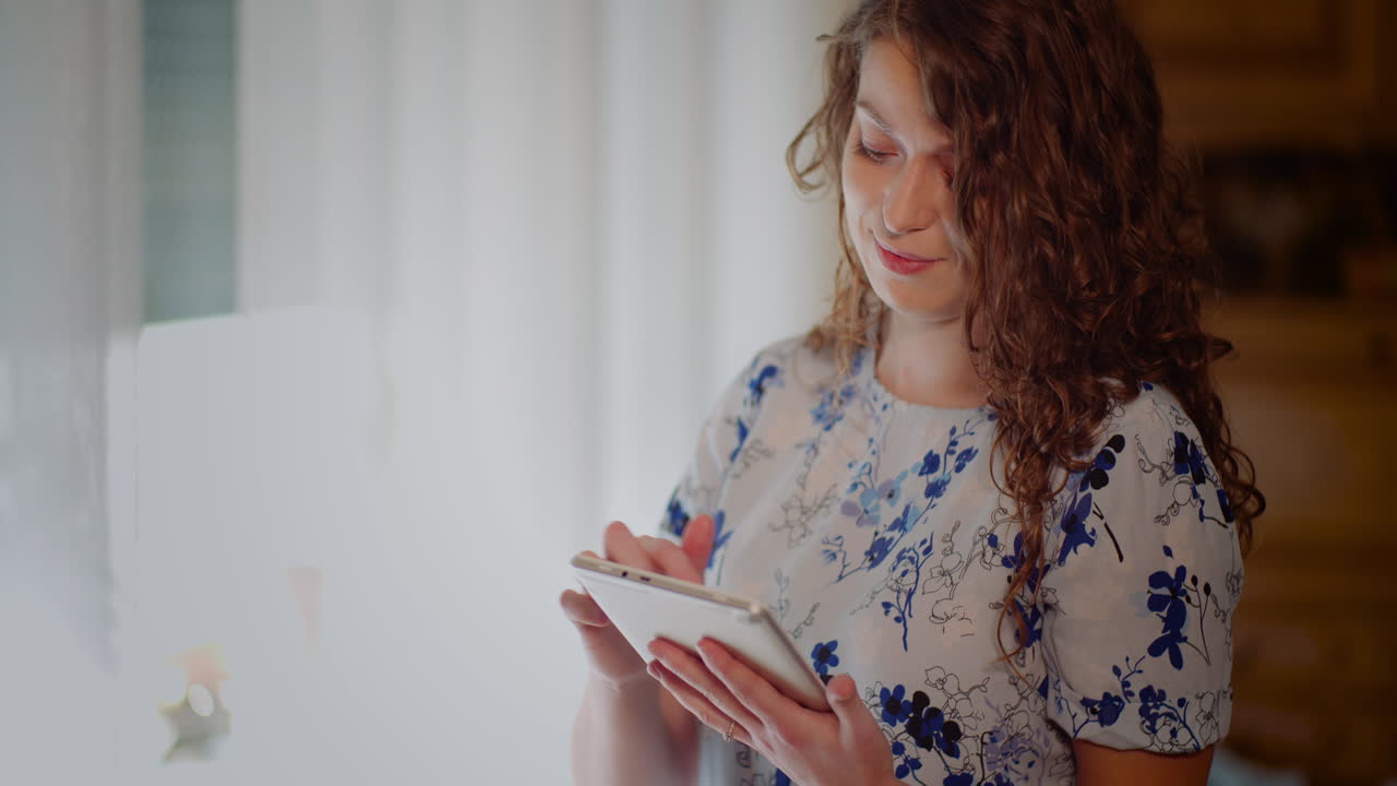 Young Woman Swiping and Using a Digital Tablet