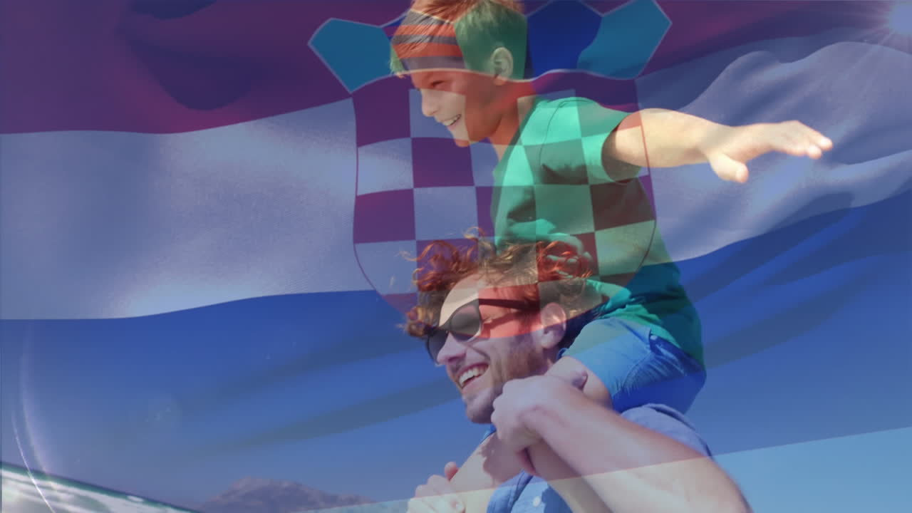 Animation of waving croatia flag over caucasian man carrying his son on his shoulder at the beach