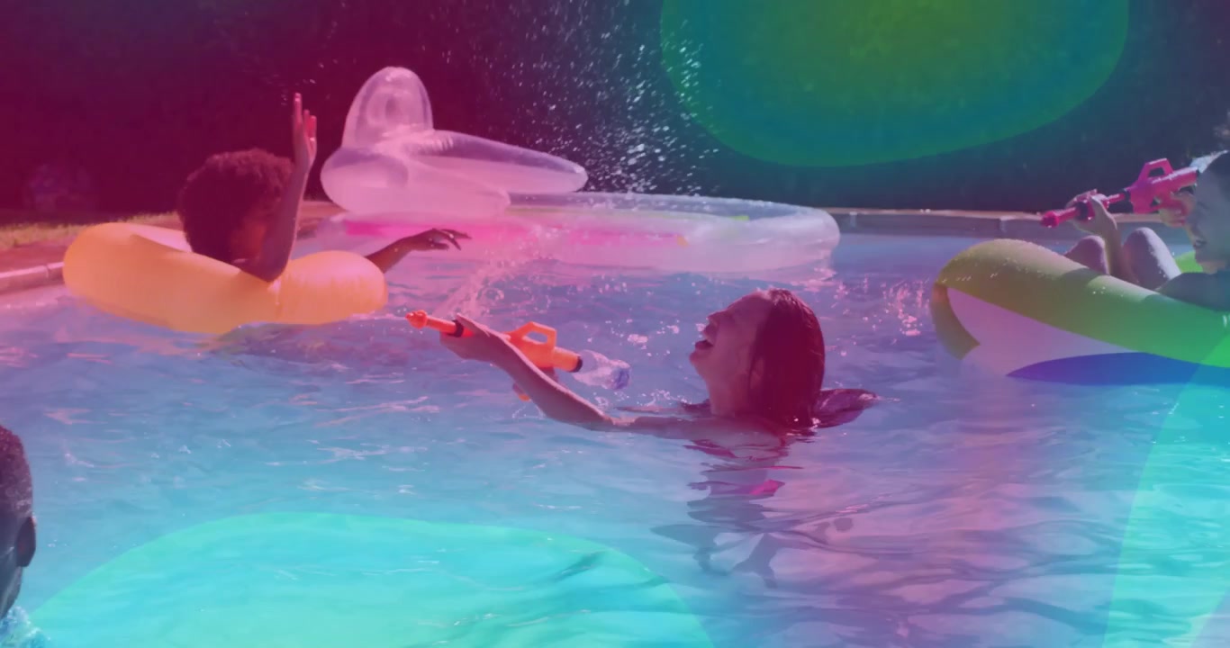 Man aiming green water gun at swimmer igniting leisure pool fight friends grabbing orange pink guns