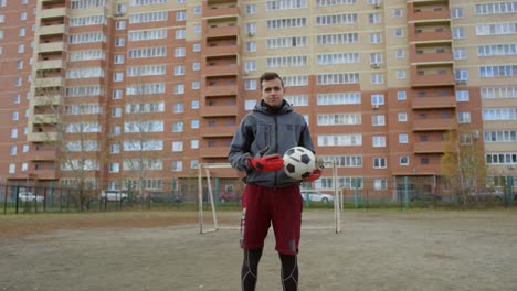 Confident-Male-Soccer-Player-With-Ball-Looking-At-Camera-On-The-Field