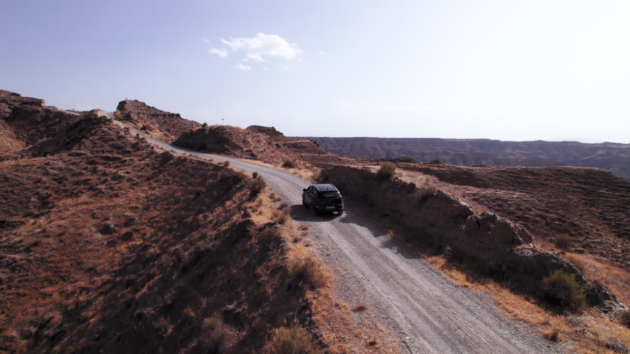Car driving through the ridge on the Gorafe desert in Granada, Spain