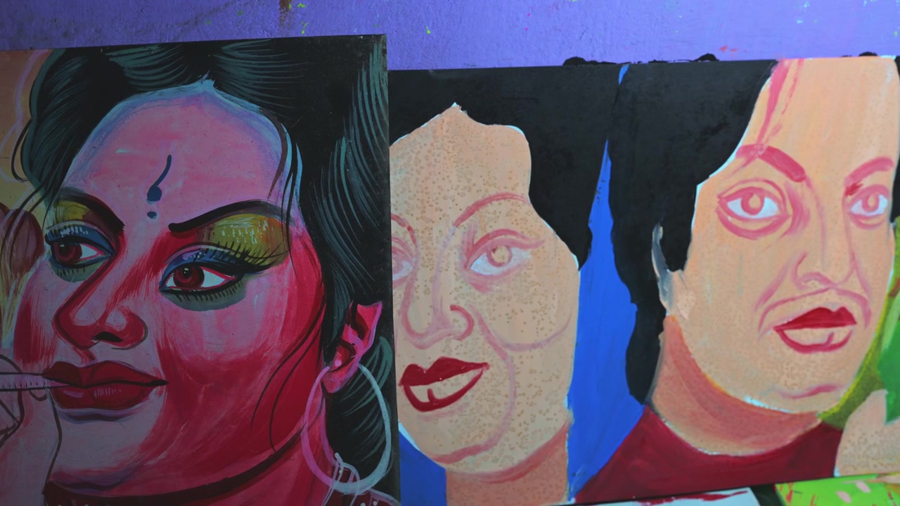 A close-up captures a Dhaka artist hand-blending black paint on retro cinema templates, crafting custom faces on rickshaw metal boards to preserve an endangered folk art custom in Bangladesh.