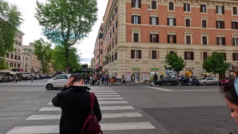 people crossing street in rome, italy