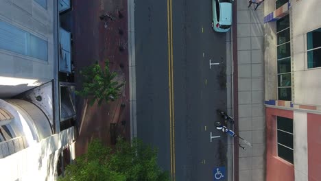 aerial view of city street with motorcycles and pedestrians