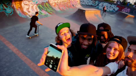 young friends taking selfies at a skate park