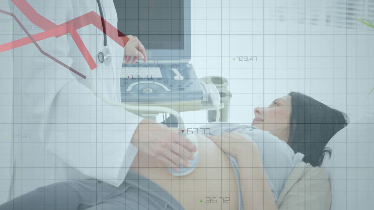 Female doctor scanning pregnant woman with ultrasound in health clinic showing monitor display