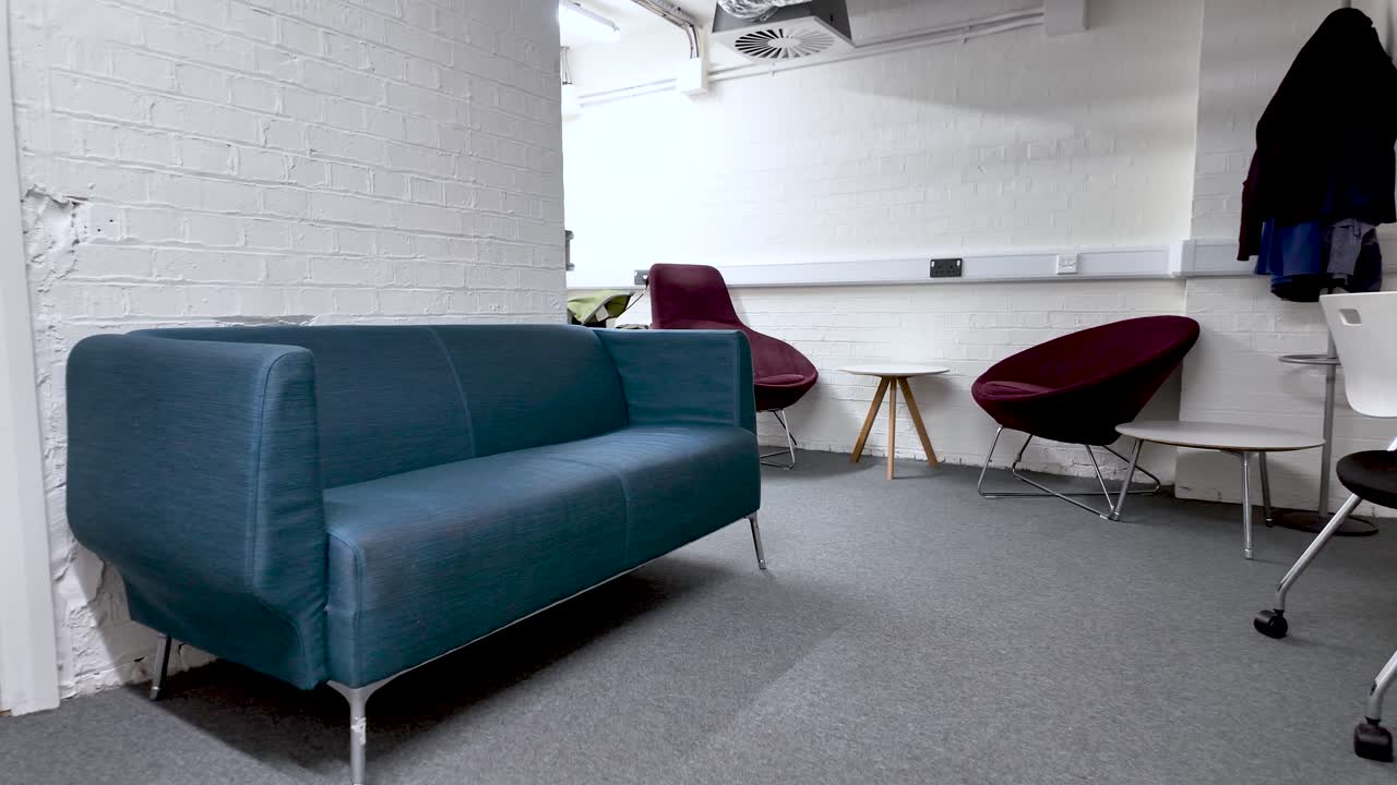 Office Downsizing And Remote Work Transition Empty Seating In Basement Office Space Corporate Restructuring And Workplace Changes Modern Furniture