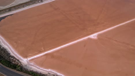 aerial flying towards large salt fields in sardinia