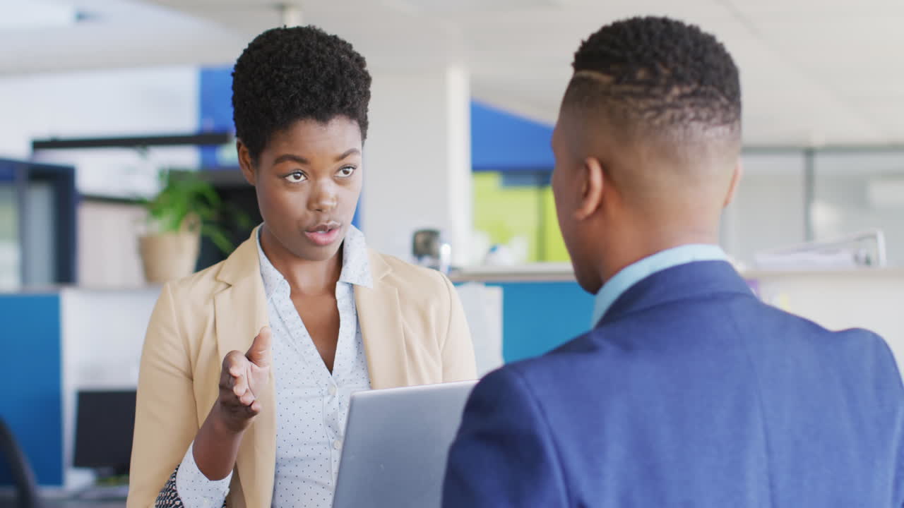 African american business people discussing work at office, slow motion