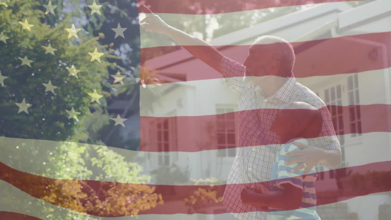 animación de la bandera de los estados unidos ondeando sobre un abuelo afroamericano con un nieto