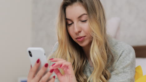 mujer usando un teléfono inteligente en casa