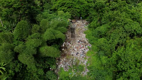 illegal garbage dump in forest mountains near countryside town of indonesia