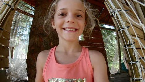 young girl sliding down a soft enclosed slide