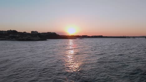 Aerial-shot-of-sunset-above-the-port-Lozenets-,-Bulgaria,-filmed-by-drone-flying-down-to-the-water