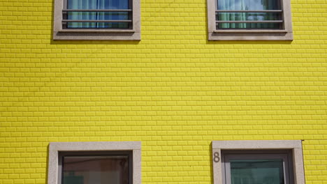 yellow brick wall of residential house in aveiro, portugal, close up