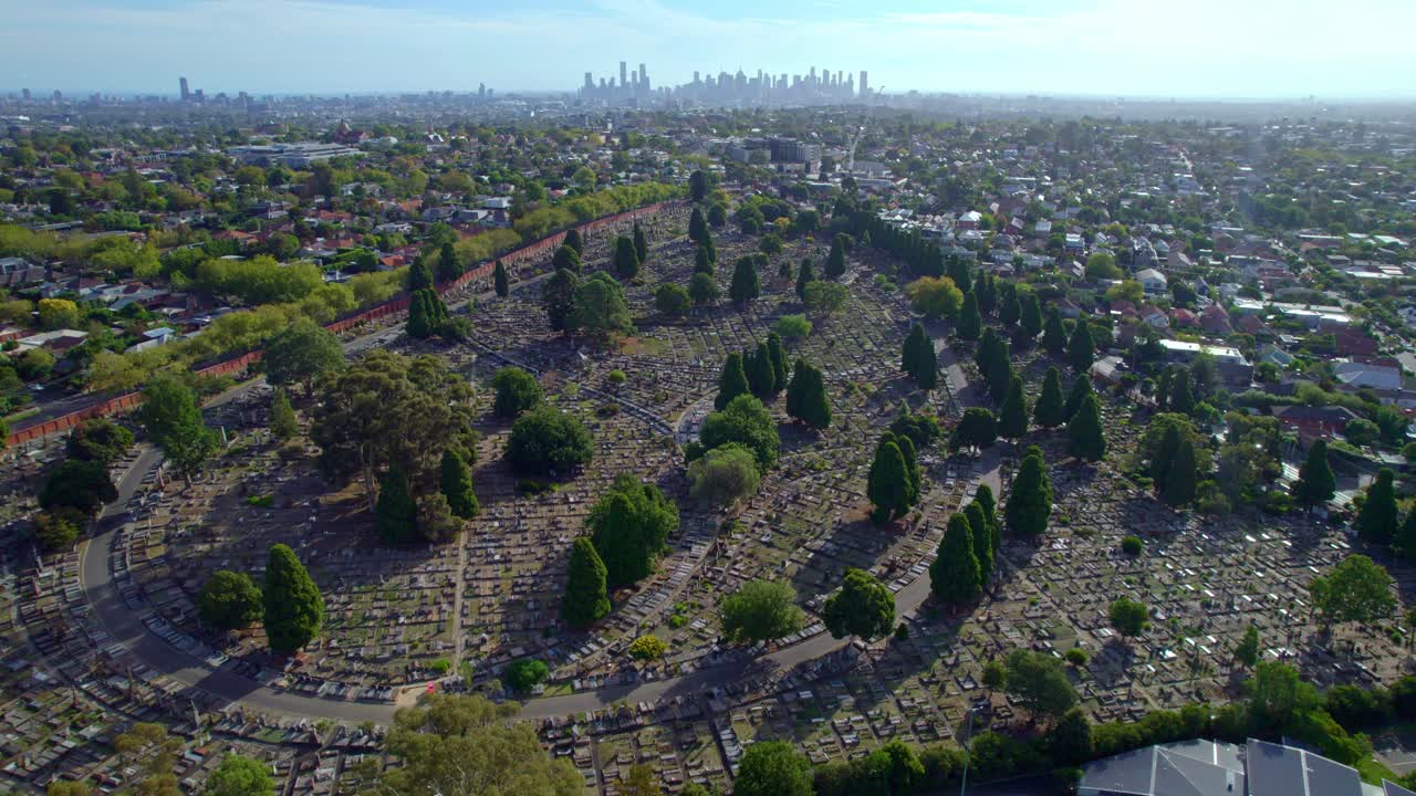 Aerial view over the Boroondara General Cemetery, with the Melborne city skyline in the background, Victoria, Australia. March 2025.