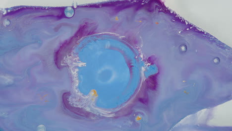 blue and white liquid mixed overflowed in a circle