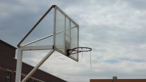 a basketball ring at school in asia with timelapse cloudy background