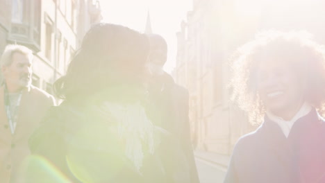 Group-Of-Mature-Friends-Walking-Through-City-In-Fall-Together