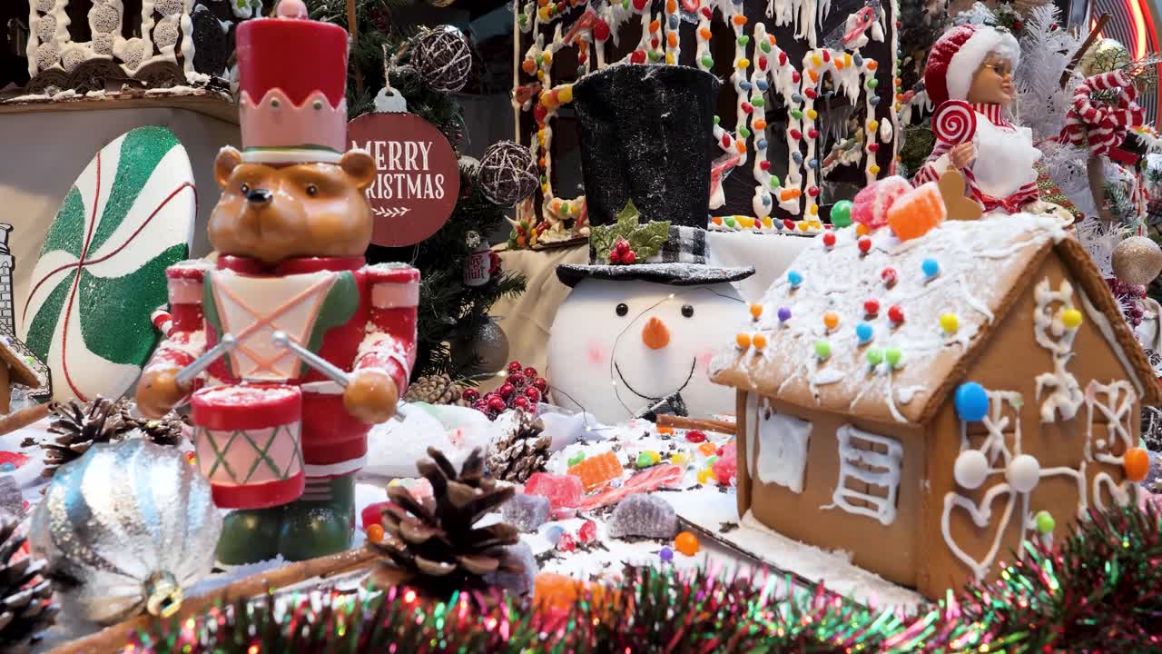 Christmas ornaments arrangement, Christmas traditions with snowman, gingerbread houses, candies, toys, Christmas tree and Christmas lights.