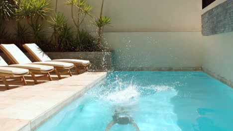 attractive woman diving into swimming pool