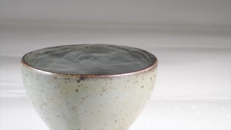 vibration of sake in ceramic glass