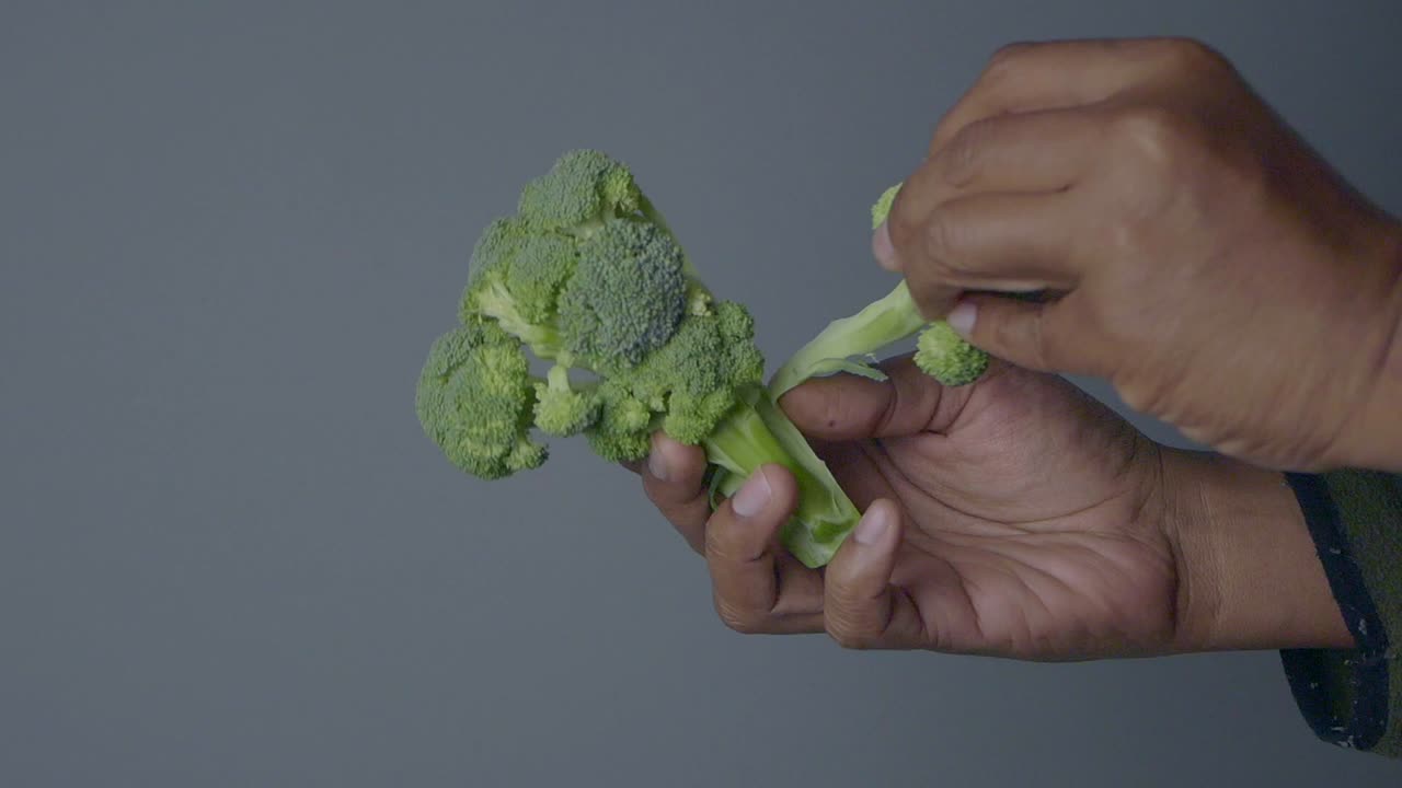 Broccoli held in hand