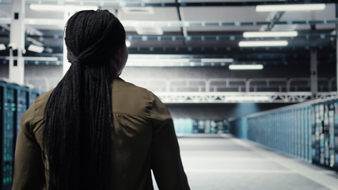 Admin in data center workplace overseeing large scale IT electronics